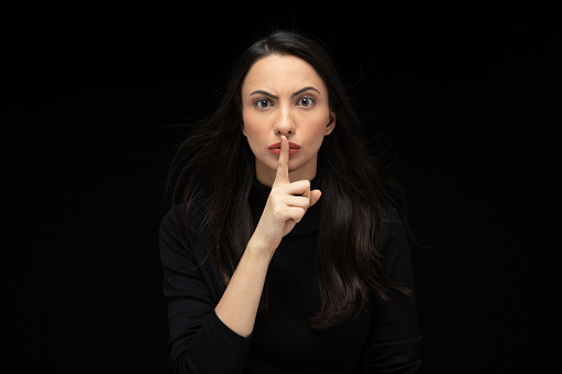 Photo of beautiful amazed girl wearing casual black t-shirt isolated black background