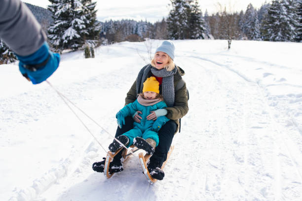 istock A Happy Family Of Three Sledding While Being On Winter Vacation 1859538291
