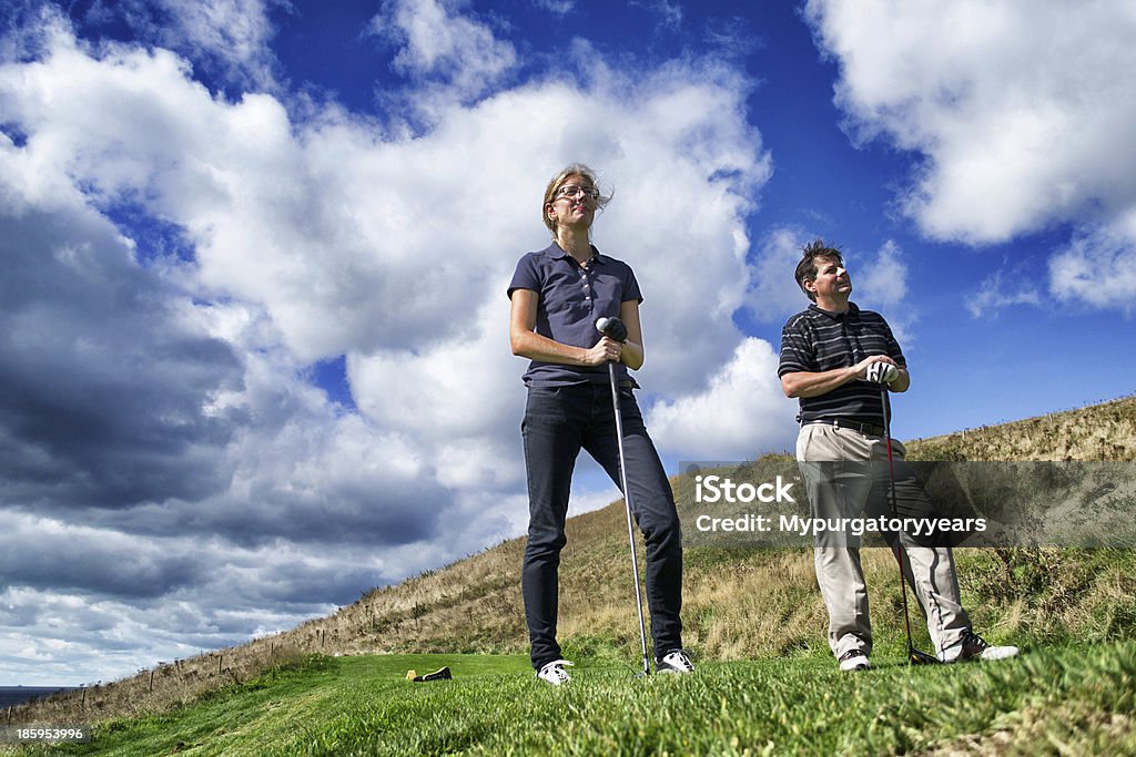 Waiting at the tee Two golfers wait their turn to play on a sunny day Golf Stock Photo