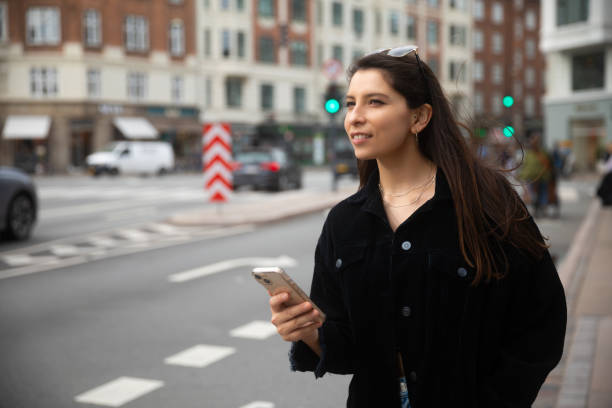 istock Young woman using smartphone on urban street 1859548714
