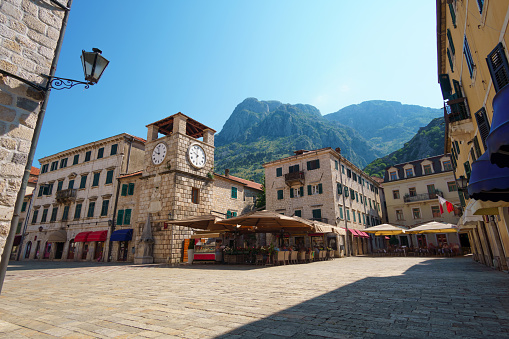 street view of the old town of Kotor, Montenegro, clock tower square, restaurants and shops for tourists, medieval European architecture, the concept of traveling through the Balkans