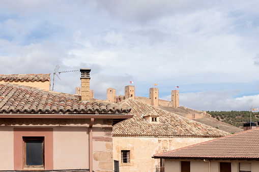 view of historic buildings and a castle under a partly cloudy sky, exuding old-world charm