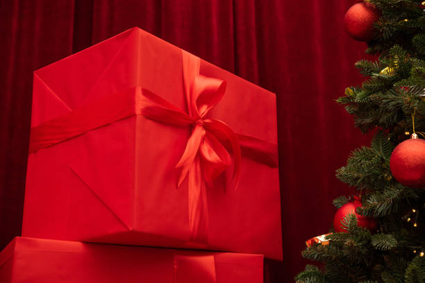 Christmas tree and gifts on a background. festive room. New Years concept. Red color box.