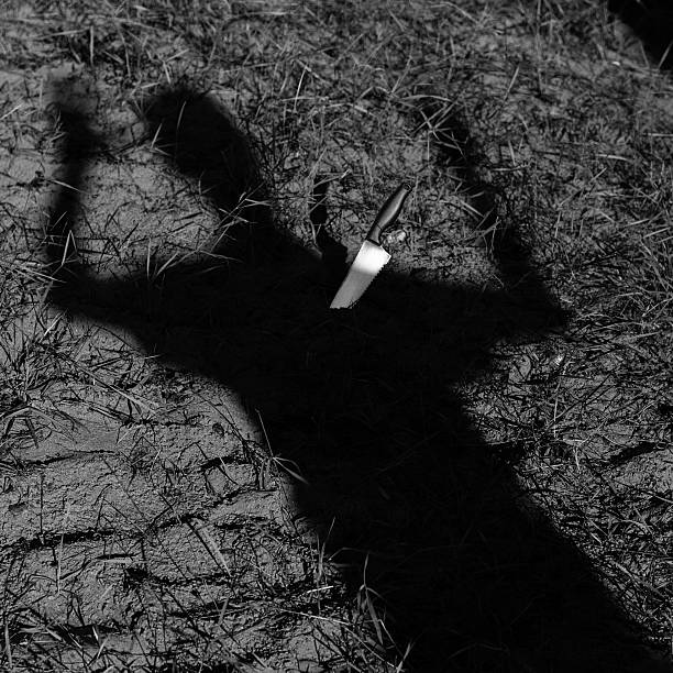 Knife Stabbing Shadow of Man stock photo