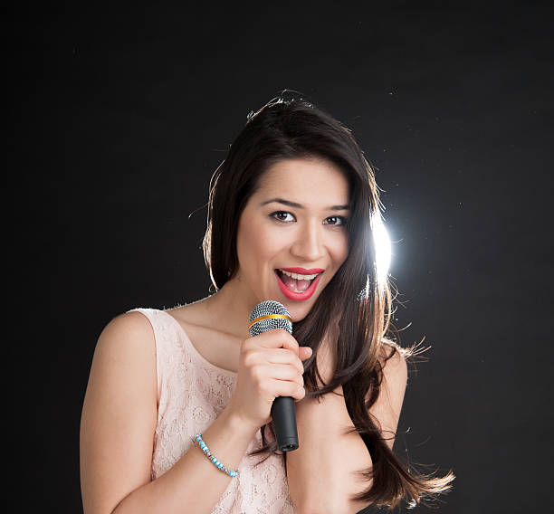 istock beautiful singer on a black background 185958847