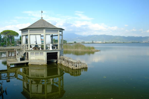 Pavilion on the lake in the village of Puccini. Pavilion on the lake in the village of Puccini. At the top is the inscription He who wants to be happy with tomorrow, there is no certainty.  Stock photos. Torre del Lago, Italy. About 2021. giacomo puccini stock pictures, royalty-free photos & images