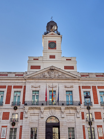 Facade of Casa de Correos building, former post office building  and currently headquarters of the Madrid regional government, with the famous clock on top. Puerta del Sol, Madrid, Spain, Europe