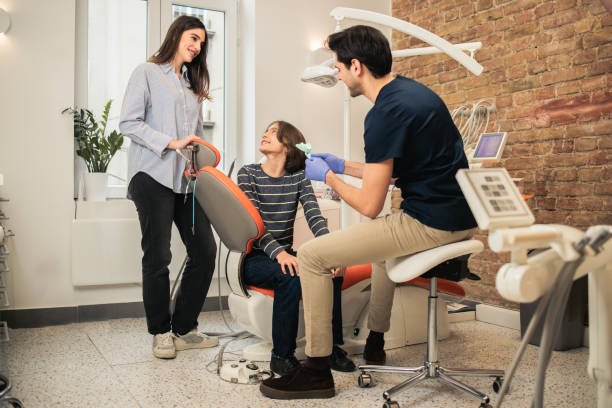 istock Mother supporting her little son at the dentist's 1859632104