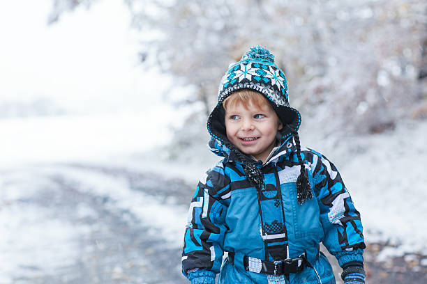 istock Adorable toddler boy having fun with snow on winter day 185965229