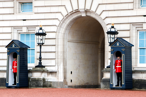 Two of the Kings or Queens guards in full uniform on duty outside Buckingham Palace - London, England, United Kingdom