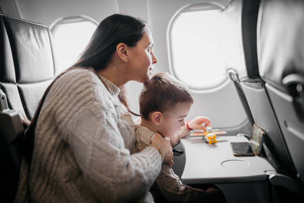 istock Young mom with her son in the Airplane 1859660393