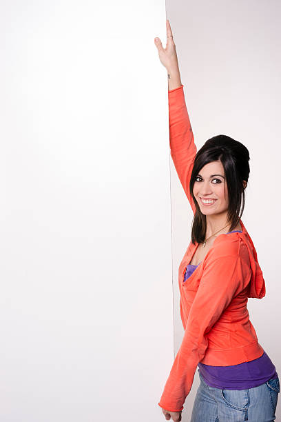 istock Female Presenter Stands At Blank White Board Smiling Woman 185967105