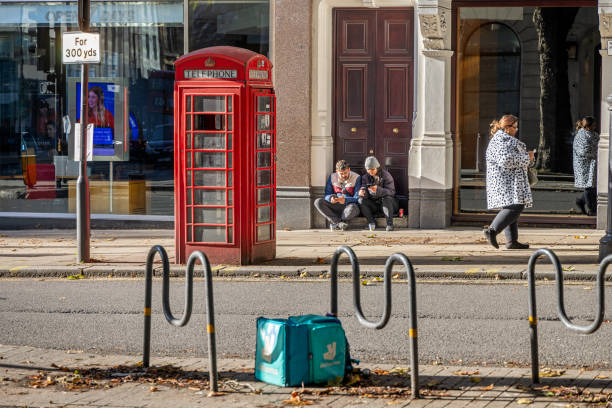 Traditional Red Pay Telephone Booth Westminster London England.  A symbol of England and the UK.