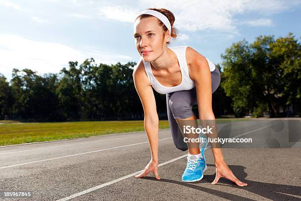 Woman Getting Ready To Start On Stadium Stock Photo - Download Image Now - Active Lifestyle, Activity, Adult