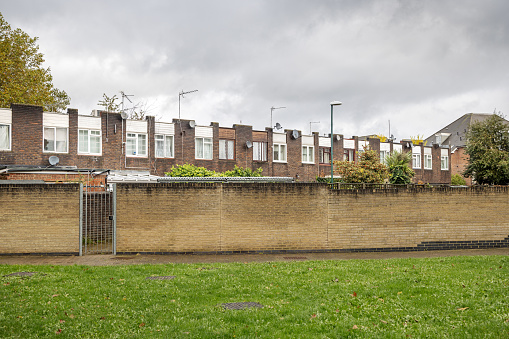 Grahame Park Way, Colindale, London, England - November 4th 2023:  Wall in front of a row of townhouses to protect them against the noise from the traffic