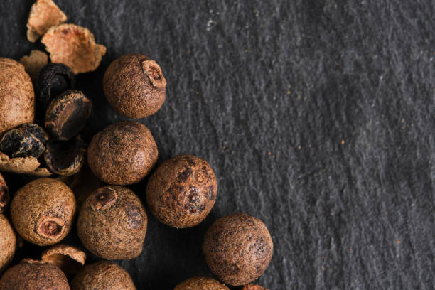istock Allspice seeds on a slate stone background. 1859699464