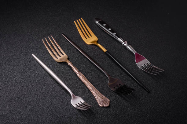 istock Kitchen fork made of steel on a dark textured background 1859709606