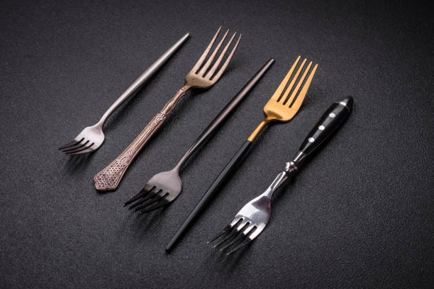 istock Kitchen fork made of steel on a dark textured background 1859710655