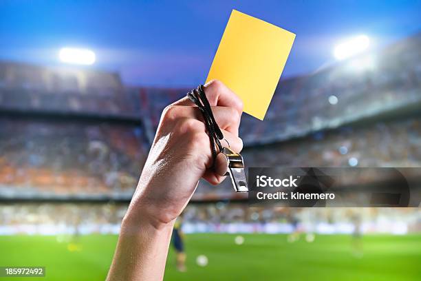 Hand Of Referee With Yellow Card And Whistle Stockfoto en meer beelden van Gele kaart - Gele kaart, Voetbal - Teamsport, Scheidsrechter
