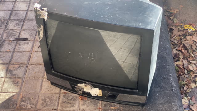 Obsolete CRT TV abandoned in the street