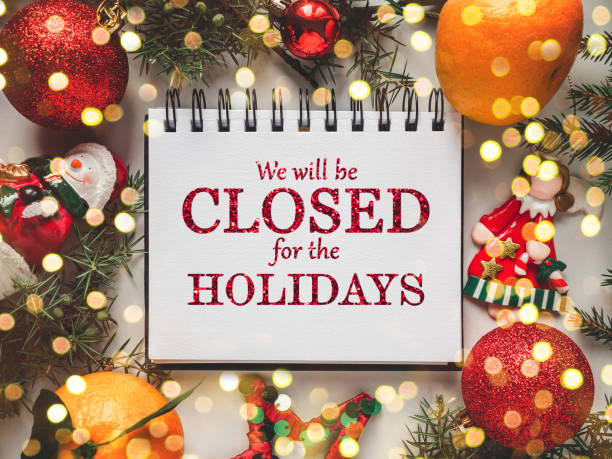 We will be closed for the Holidays Signboard with the inscription We will be closed for the Holidays. Christmas decorations lying on an empty table. Close-up, indoors. Studio shot closed sign stock pictures, royalty-free photos & images