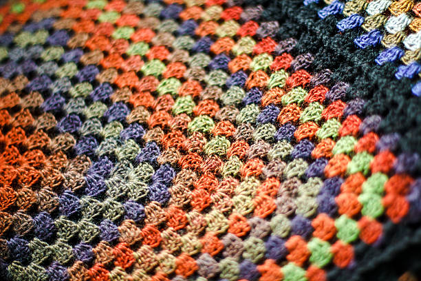 Handmade crochet multicolored afghan blanket of granny squares. stock photo