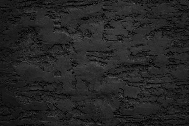 istock Black or dark gray rough grainy stone or sand plaster texture background 1859775580
