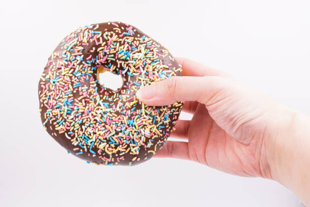 istock Milk chocolate coated donut with sprinkles 1859798097