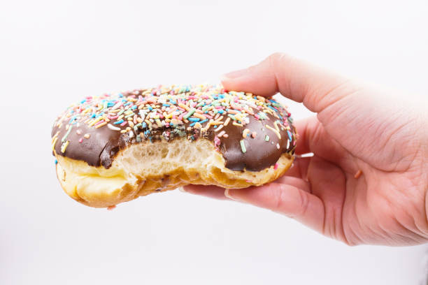 istock Milk chocolate coated donut with sprinkles 1859798177