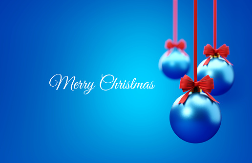 Blue Christmas baubles and Merry Christmas message over blue background. Christmas and festivity concept. Horizontal composition with selective focus and copy space.