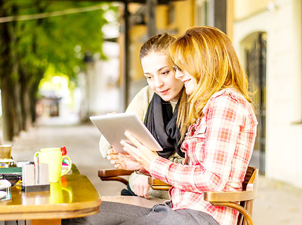 istock Happy friends looking at digital tablet 185980256