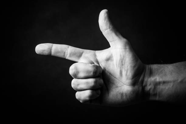 istock Finger pointing to the left, weapon shaped hand. Hand gesture isolated on white. 1859807678