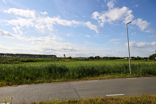 Pastures with farms and roads in the future Fifth Village of the Zuidplaspolder of the municipality of Zuidplas in the Netherlands