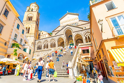 Amalfi, Italy - 13 May, 2023: Scenic view of Amalfi Cathedral and central square Piazza del Duomo, people walking up stairs.
