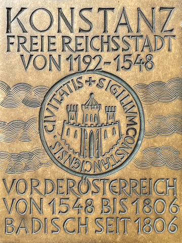 Metal plate on a street in the old town with data on the history of Konstanz on Lake Constance - Germany.