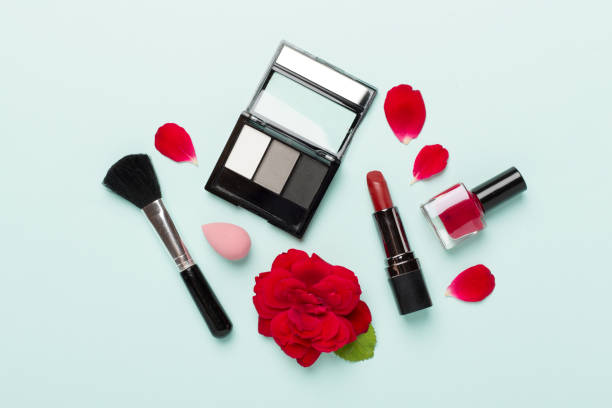 istock Flat lay with makeup products and tools with flowers on color background 1859836133