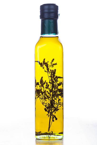 istock Olive oil in glass bottle with herb inside 185984226
