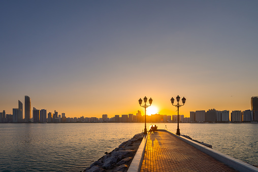 Abu Dhabi, UAE-Dec, 1 2023: Sunrise of the skyline Abu Dhabi city in Corniche , Marina.