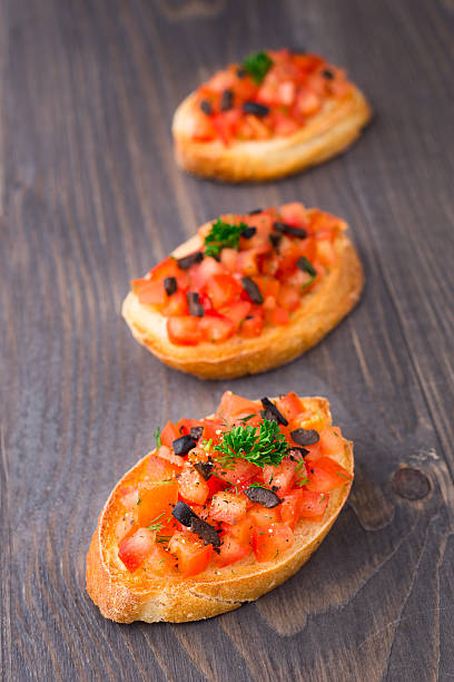 istock Tomato bruschetta topped with olive 185988472