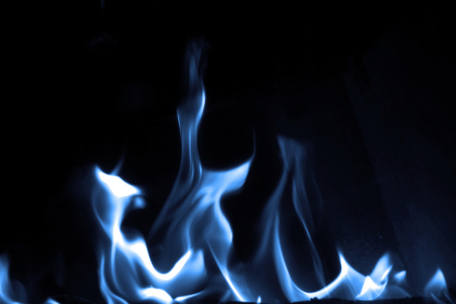 Blue flame isolated on dark background
