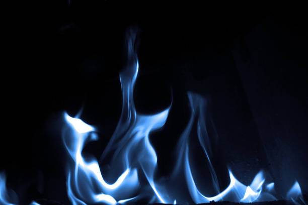 Blue flame Blue flame isolated on dark background blue flames stock pictures, royalty-free photos & images