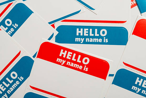 Stack of name tags or badges A stack of blue and red "Hello, my name is" name tags or badges name tag stock pictures, royalty-free photos & images