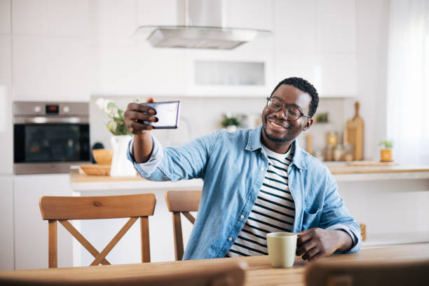 istock Young black man making a selfie by his smart phone 1859895540