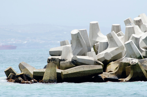 A stack of Dolosse on a breakwater seen from the sea