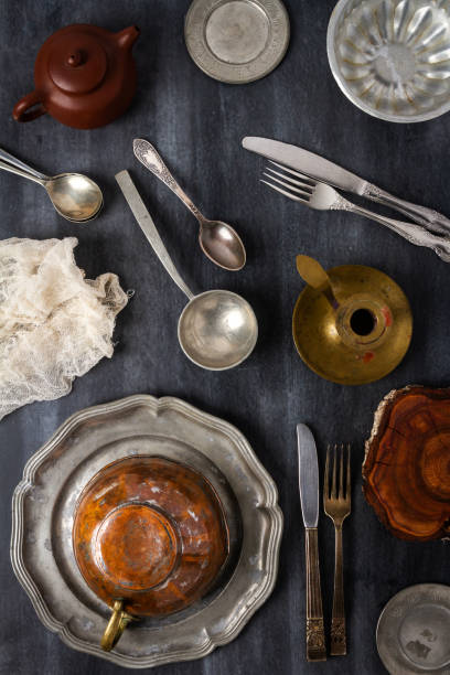 istock Various antique vintage dishes on black background 1859932863