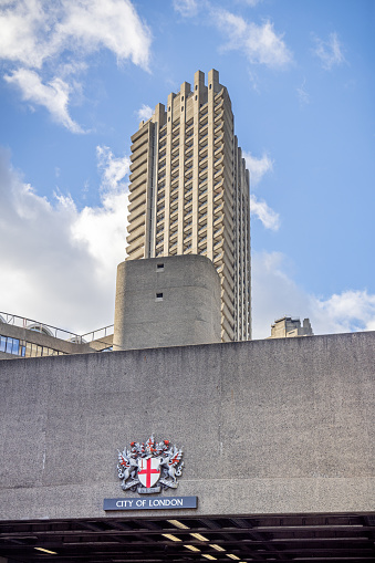 Barbican Centre, London, England - November 5th 2023: Modern high rise building in the middle of old London with the coat of arms of greater London