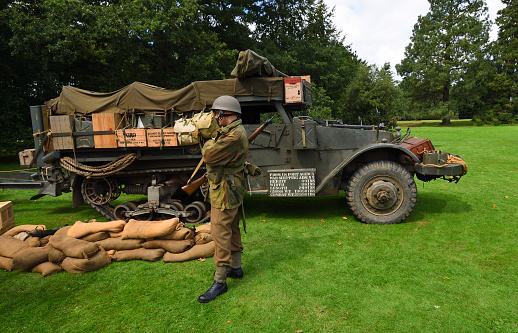 Silsoe, Bedfordshire, England - August 19, 2023: Vintage M3 Armoured Half Track with armed soldier.