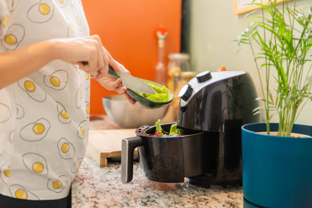 istock Putting vegetables to the airfryer compartment 1859955545