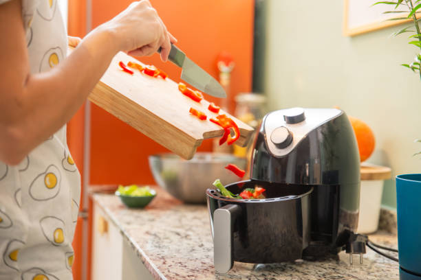 Putting vegetables to the airfryer compartment
