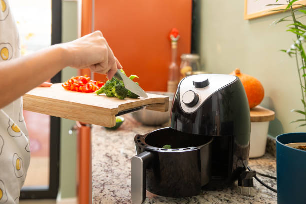 istock Putting vegetables to the airfryer compartment 1859960964